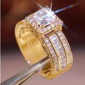 Geometric women's fashion ring with a round detail, shown in gold and white finishes on a hand.