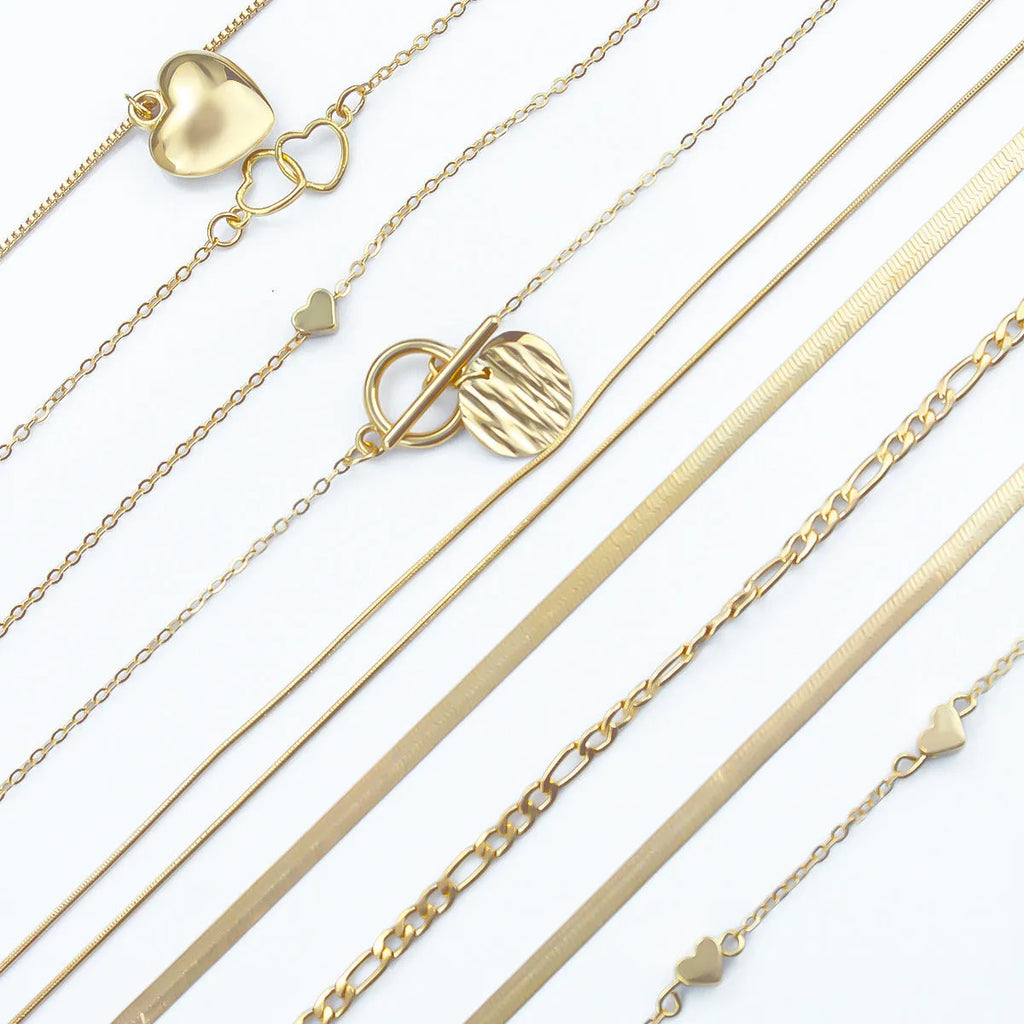Set of ten simple gold women's necklaces with alloy pendants on snake bone chains.