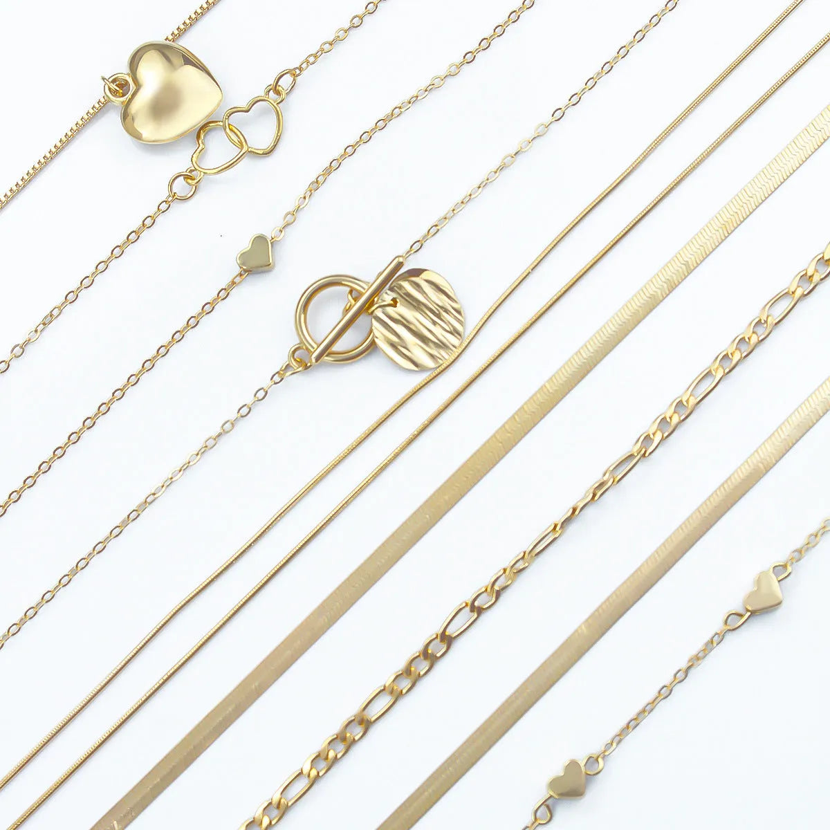 Set of ten simple gold women's necklaces with alloy pendants on snake bone chains.