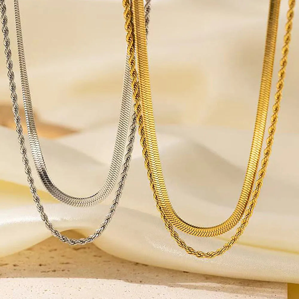 Women's silver geometric pendant necklace with an adjustable double-layer twist chain on a grey background.