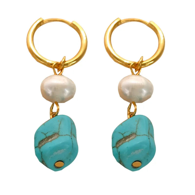A pair of geometric copper clip-on earrings featuring irregular blue-green turquoise stones and white cultured pearls.
