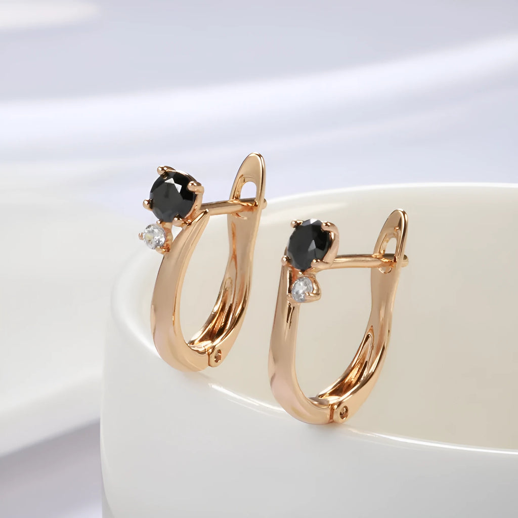 Gold geometric drop earrings with black agate stone accents on copper base