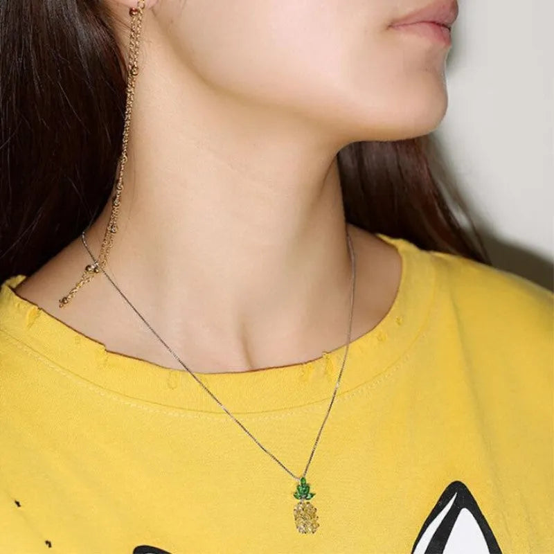 Silver plated women's necklace with a geometric pineapple pendant and diamond charm.