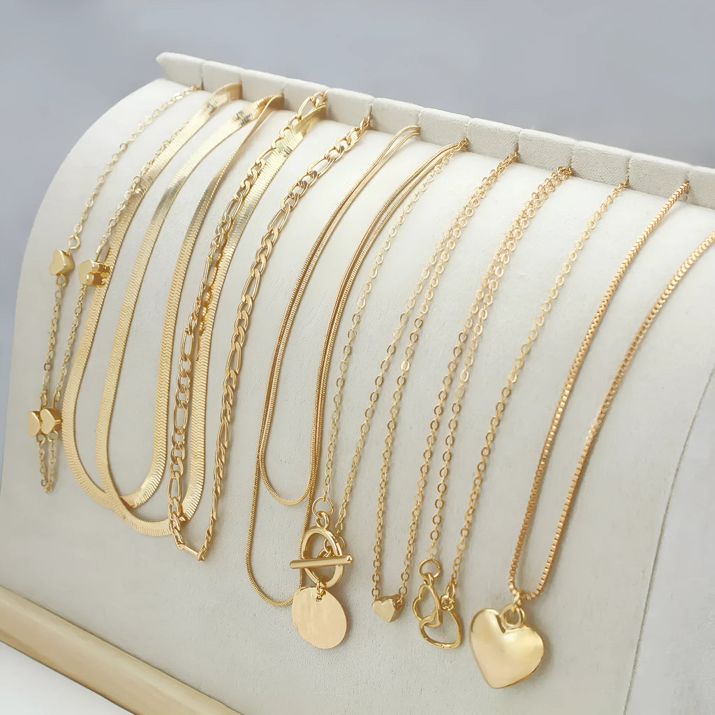 Set of ten simple gold women's necklaces with alloy pendants on snake bone chains.