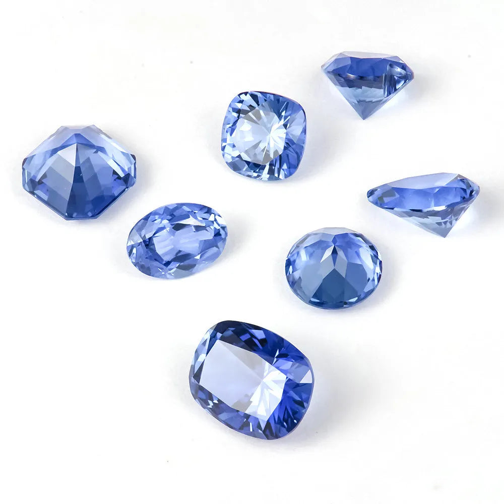 Loose blue heart-shaped cultivated sapphire gemstone on a jewellery cloth.