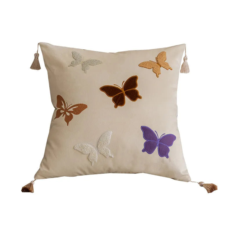 Square beige couch pillow with embroidered Chinese-style butterfly design.