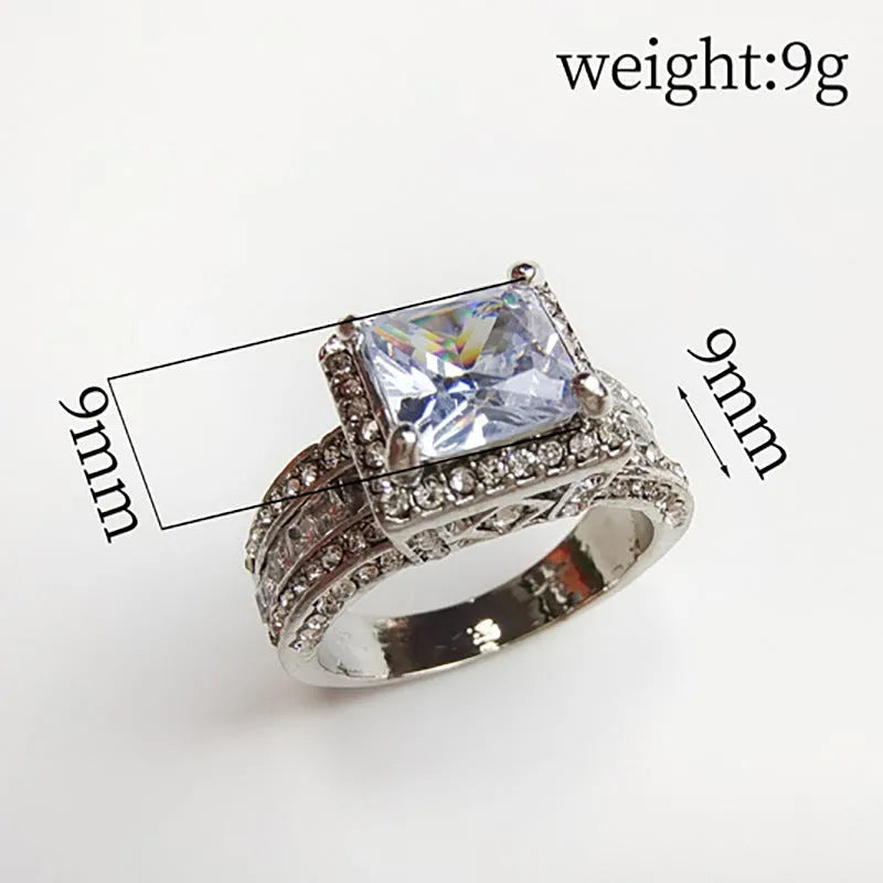 Geometric women's fashion ring with a round detail, shown in gold and white finishes on a hand.