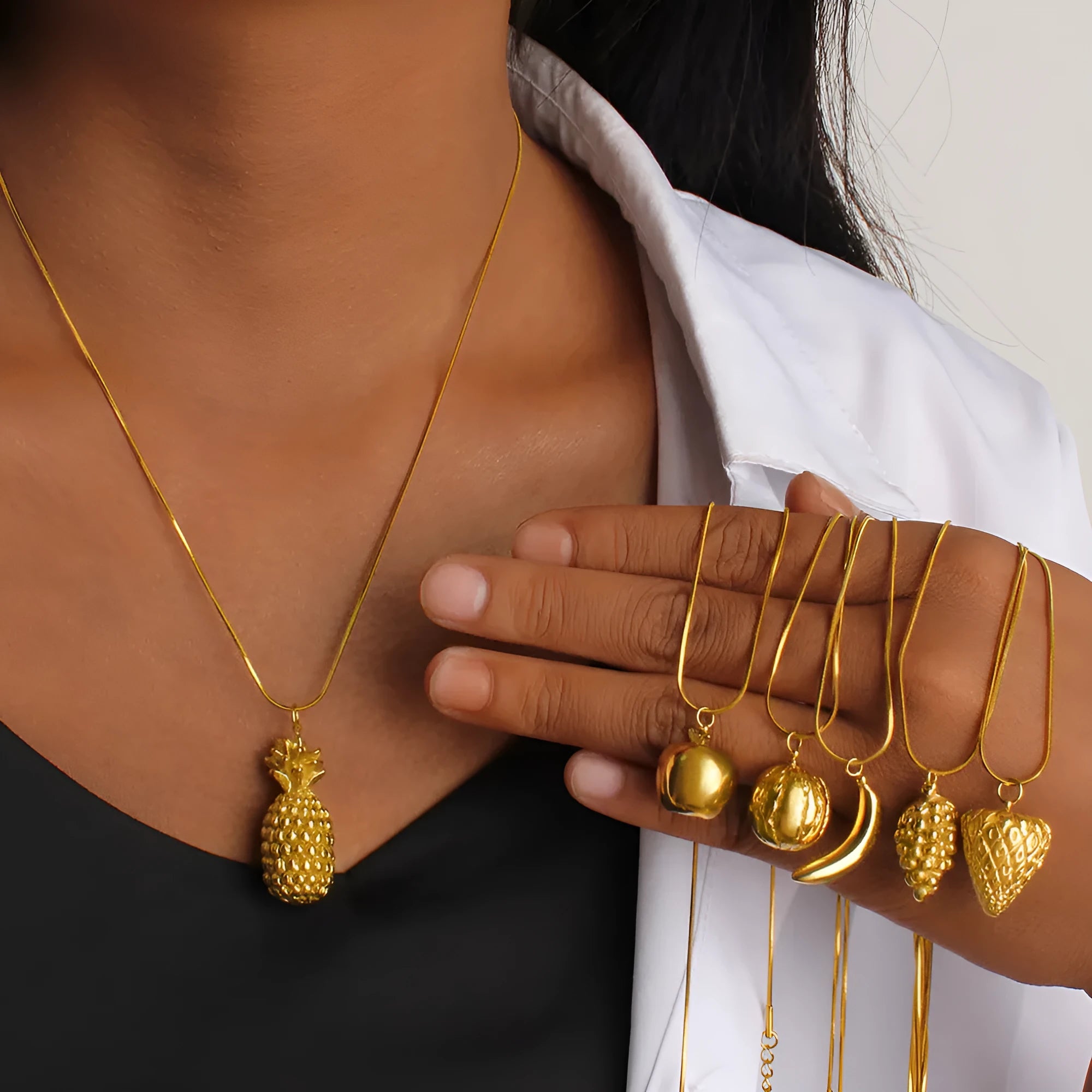Stainless steel necklace with a detailed fruit-shaped pendant on a silver-tone chain.