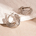 Gold and silver geometric women's hollow stud earrings with a twisted round design