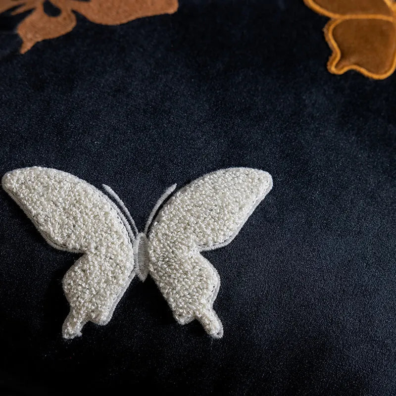 Square beige couch pillow with embroidered Chinese-style butterfly design.