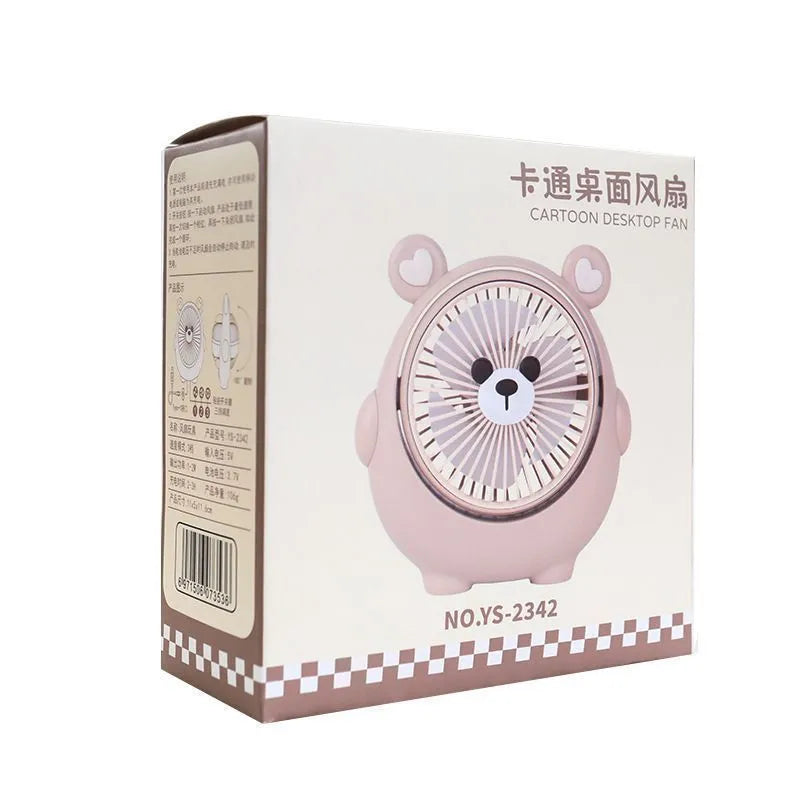 Cute dog-themed USB desktop electric fan in apricot puppy colour on a wooden desk.