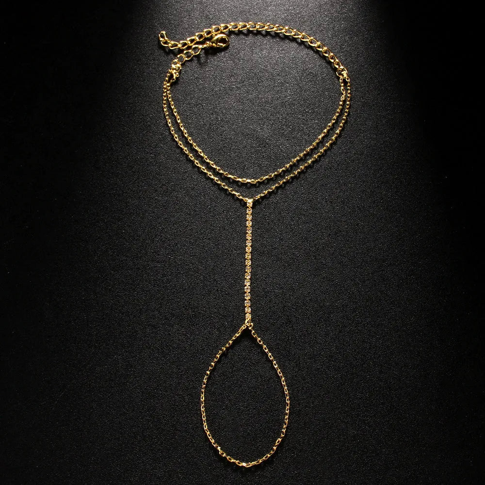 Women's geometric-shaped rhinestone bracelet in silver or gold colour on a wrist.