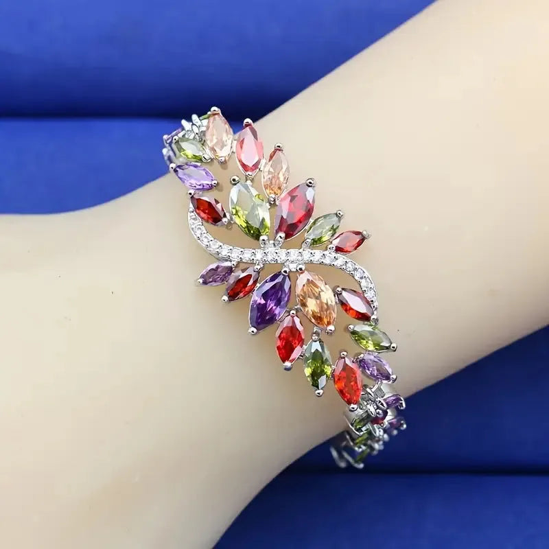 Gold electroplated copper bracelet with ice flower design and blue zircon stones