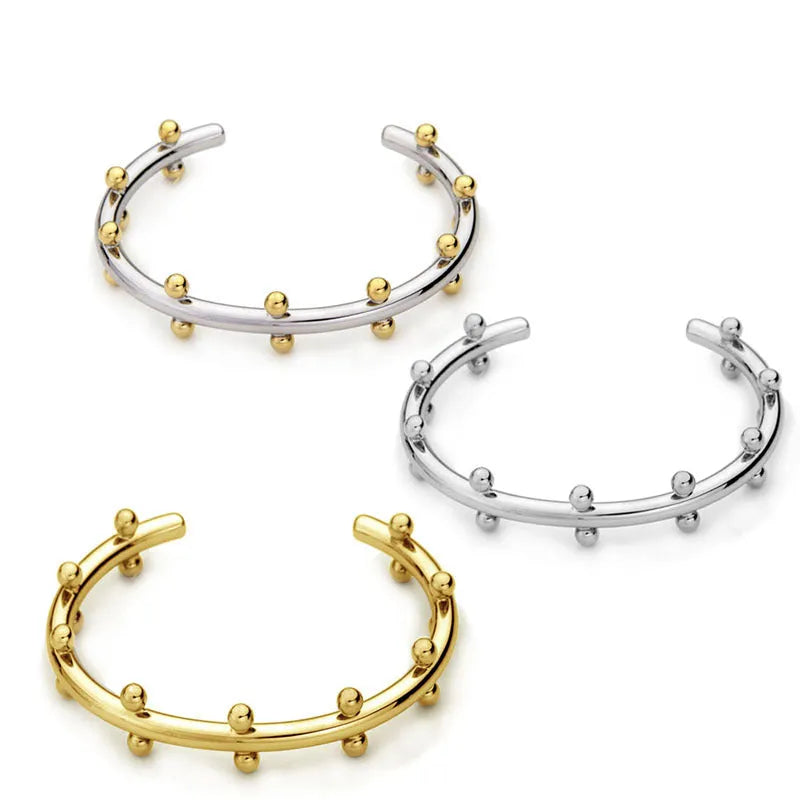 Stainless steel C-shaped bracelet with rivet-shaped bean beads in gold tone