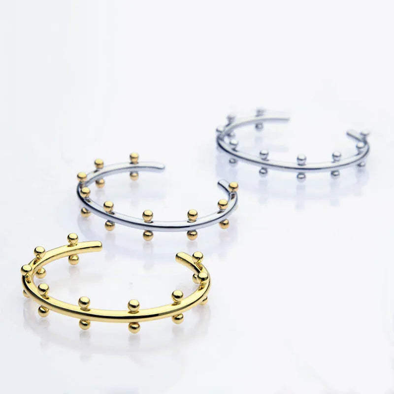 Stainless steel C-shaped bracelet with rivet-shaped bean beads in gold tone