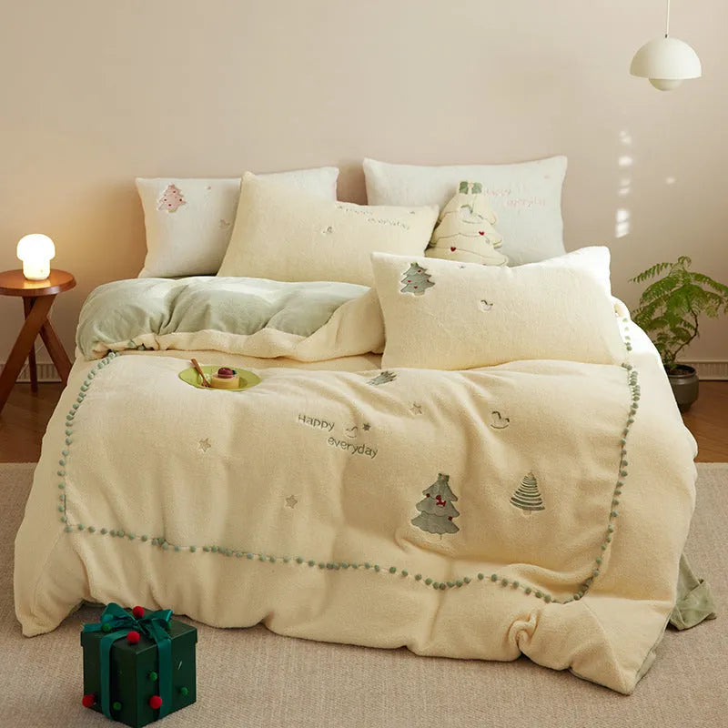 Milk fibre bedding four-piece set with green Christmas tree pattern on a bed.