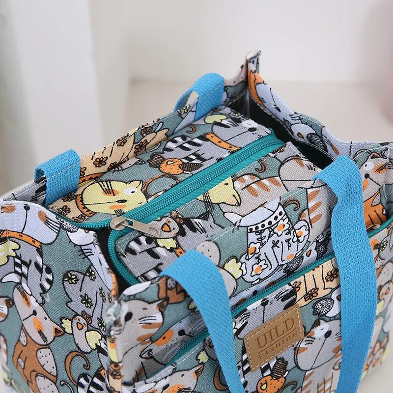 Women's printed canvas handbag with an aluminium handle in a floral design colour.