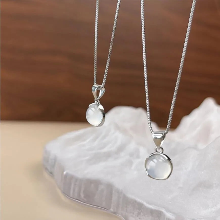 Women's oval geometric pendant necklace with artificial crystal on an adjustable silver-toned box chain.