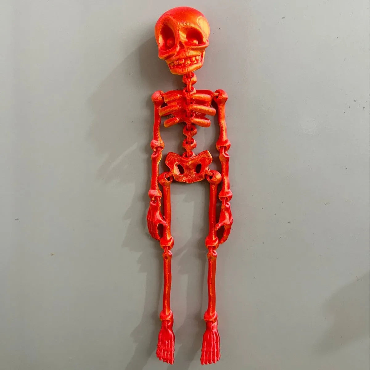 A detailed 3D printed white skull refrigerator magnet, 18cm tall, against a dark background.