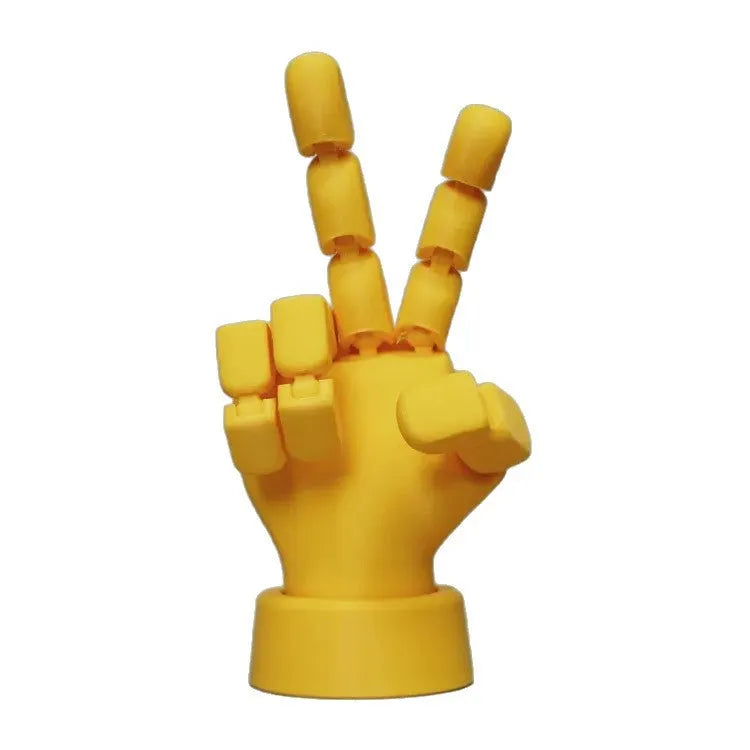 Yellow movable joint hand prop ornament made from PLA plastic on a plain background