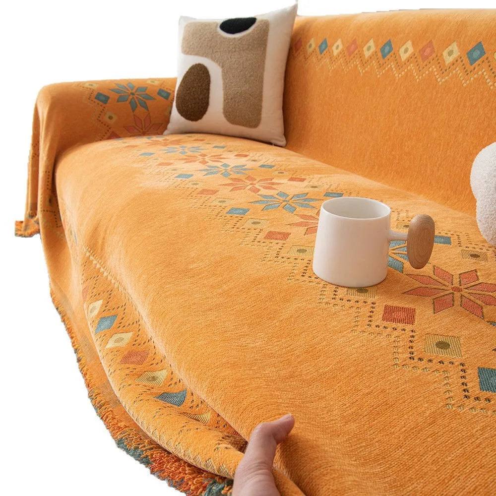 Universal chenille sofa cover in beige with Nordic west blanket pattern on a modern sofa