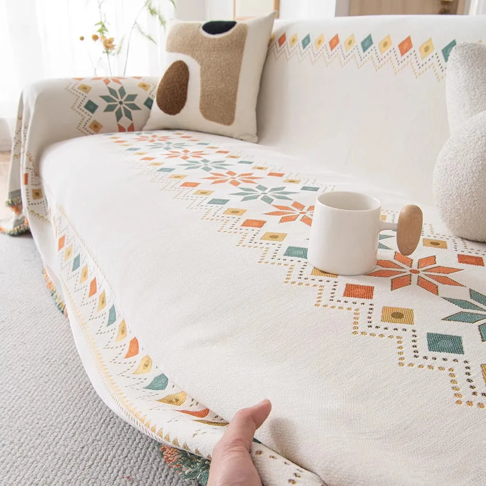 Universal chenille sofa cover in beige with Nordic west blanket pattern on a modern sofa