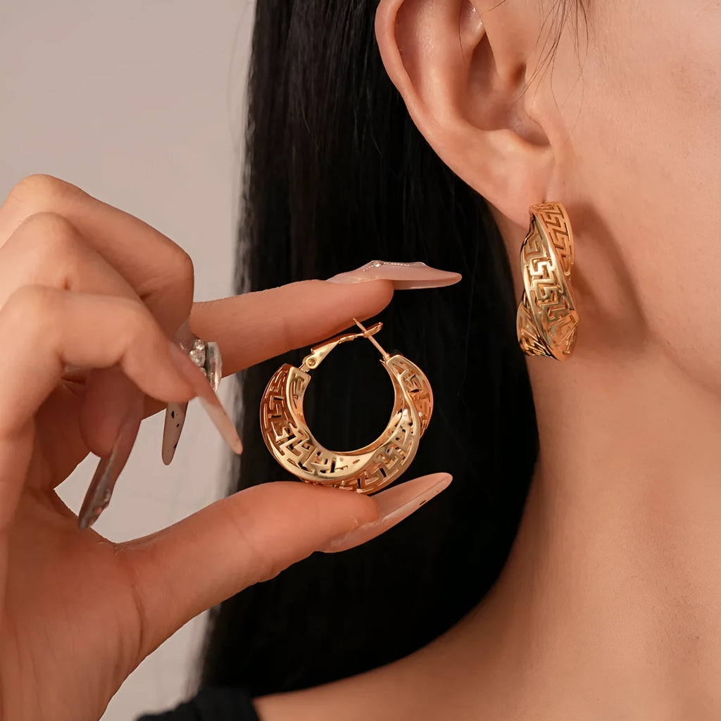 Gold and silver geometric women's hollow stud earrings with a twisted round design