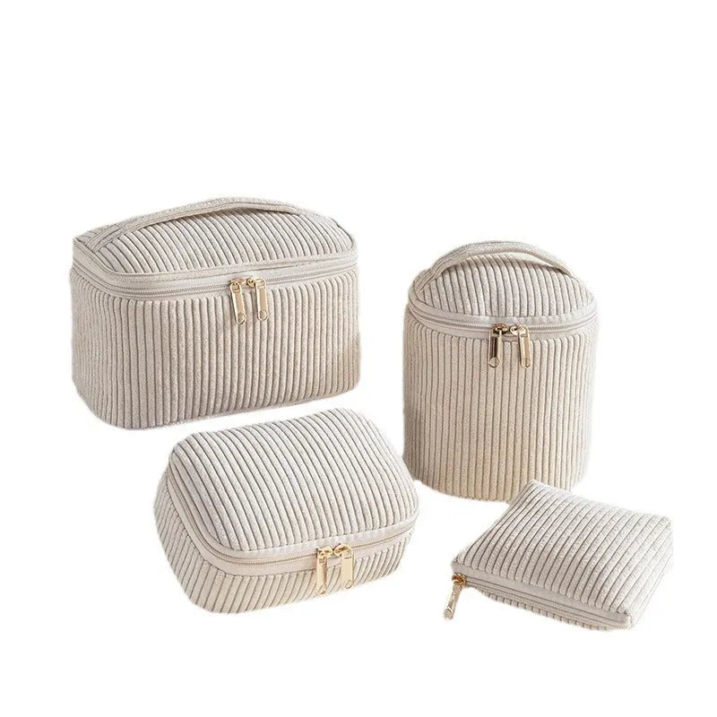 Set of four pink, khaki, and polka dot cube-shaped flannelette makeup bags for travel organisation.