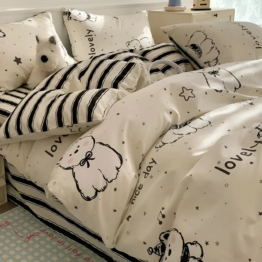 Cartoon dog print cotton duvet cover and pillowcases on a bed, part of a four-piece bedding set.