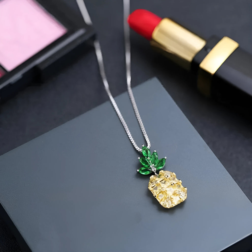 Silver plated women's necklace with a geometric pineapple pendant and diamond charm.