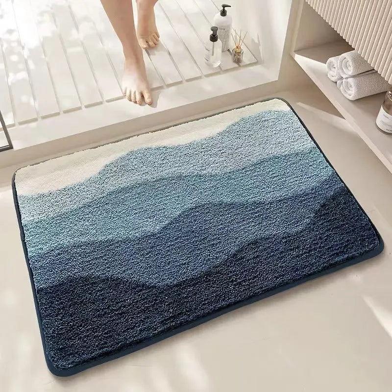 Square rainbow print floor mat with sky and sea colours on a wooden floor