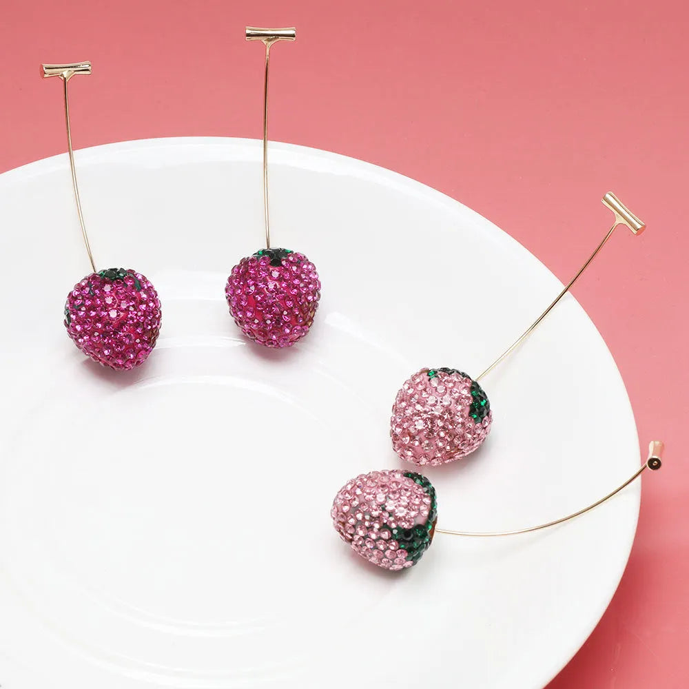 Pair of geometric strawberry stud earrings with spot drill texture in red zinc alloy, shown from front.