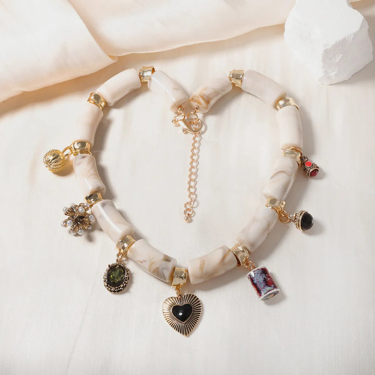 Gold-tone heart-shaped resin bamboo pendant necklace with electroplated chain