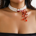 Gold tone gothic pearl collar jewellery set with U-shaped necklace, bracelet, and stud earrings.