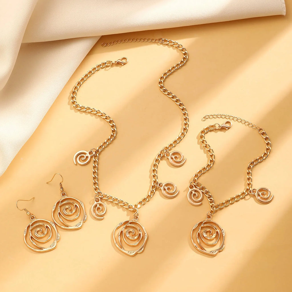 Spiral donut jewellery set showing necklace, bracelet and ear hooks with geometric circle designs in gold finish