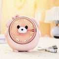 Cute dog-themed USB desktop electric fan in apricot puppy colour on a wooden desk.