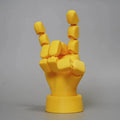 Yellow movable joint hand prop figurine ornament on a white background.
