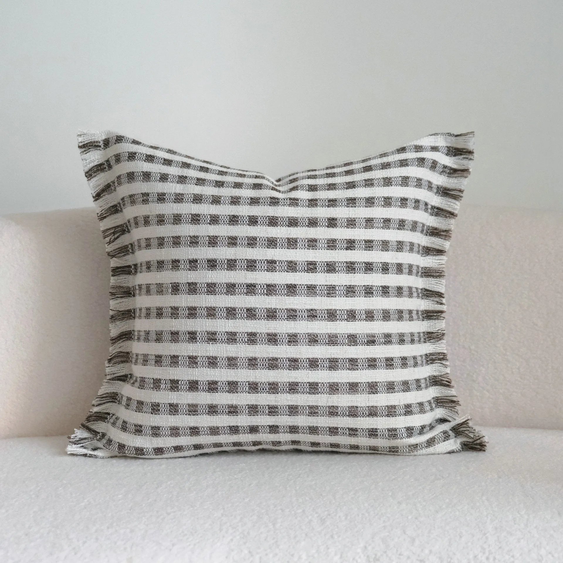 Coffee brown striped decorative cushion on a grey sofa, showing lumbar and square size options.