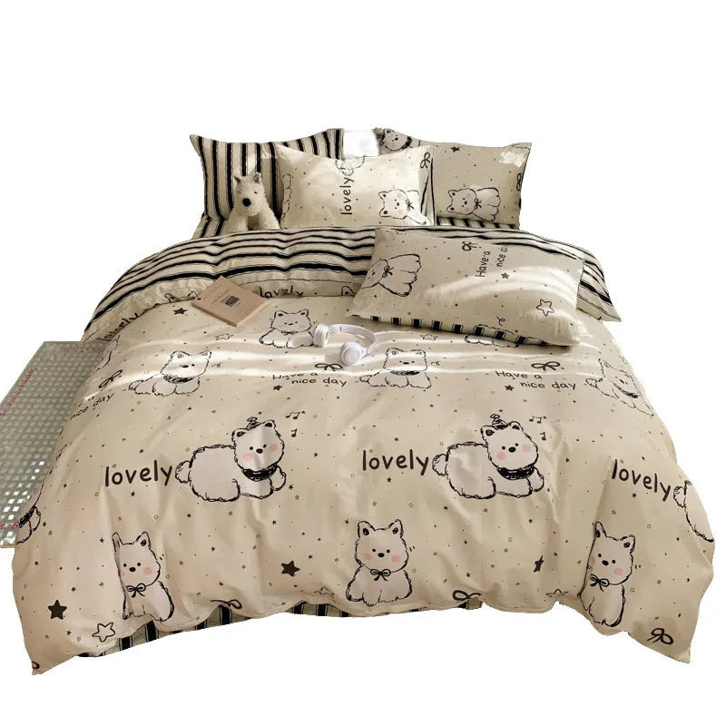 Cartoon dog print cotton duvet cover and pillowcases on a bed, part of a four-piece bedding set.