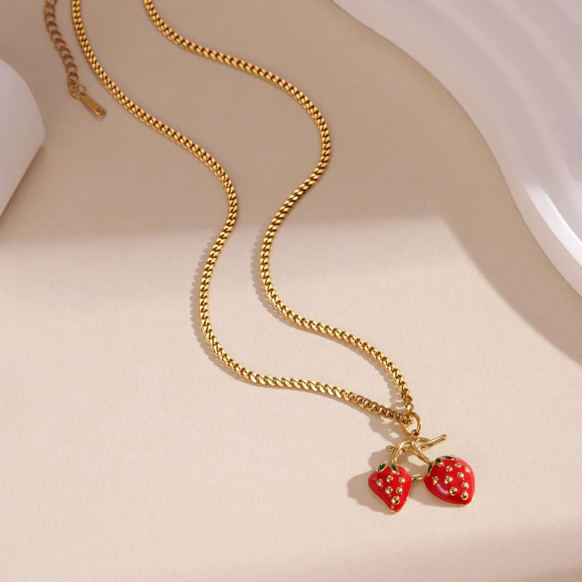 Women's strawberry fruit pendant necklace in red or white powder gradient on a metal chain.