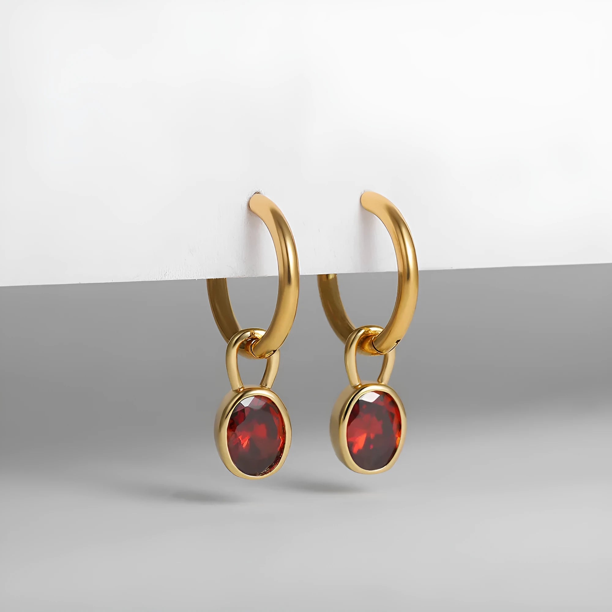 Close-up of a women's retro-style oval zircon earring in copper, showing elliptical stone setting and textured metal finish.