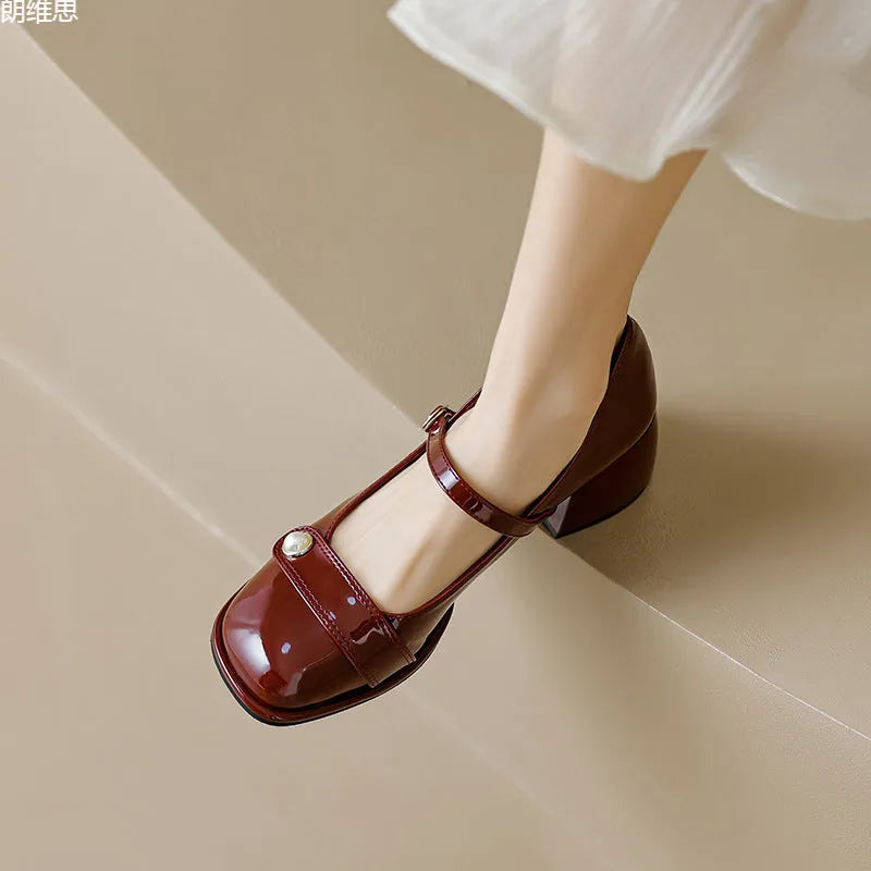 Women's apricot patent leather chunky heel ankle boots with a square toe and ankle buckle.