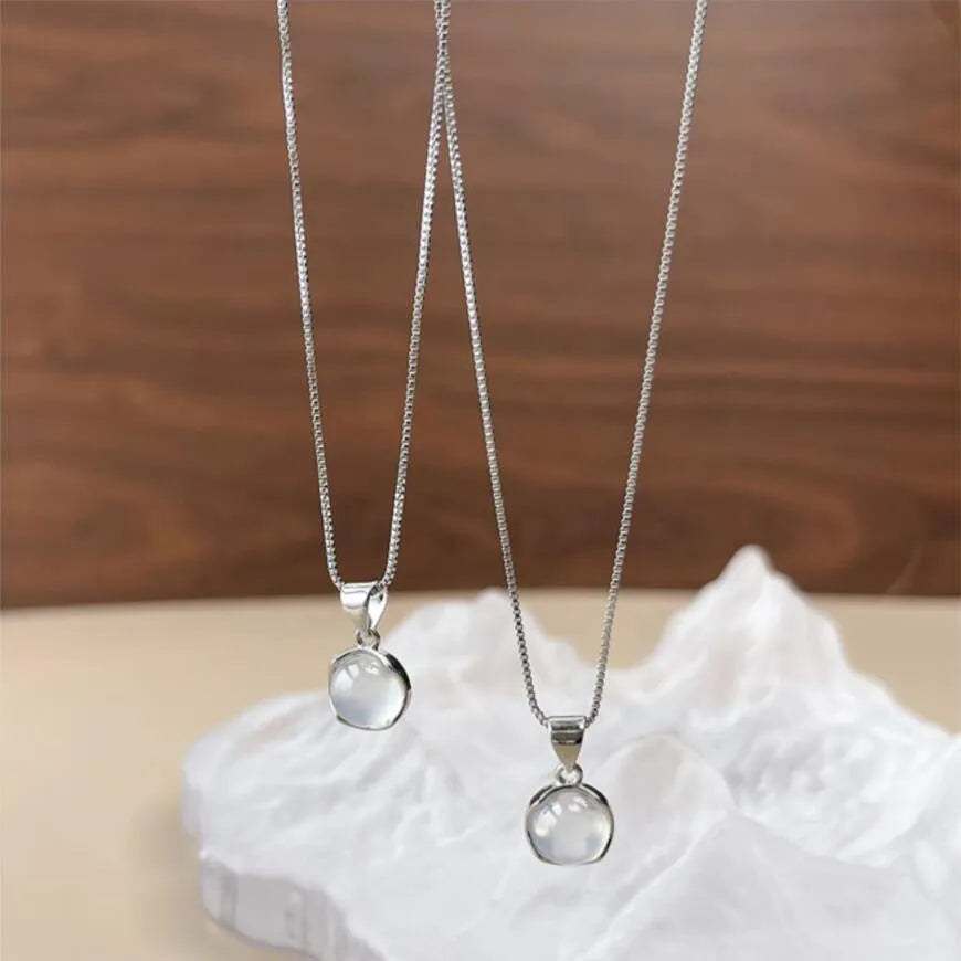 Women's oval geometric pendant necklace with artificial crystal on an adjustable silver-toned box chain.