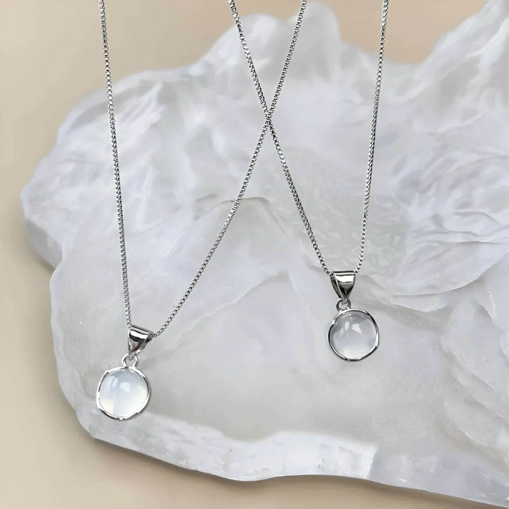 Women's oval geometric pendant necklace with artificial crystal on an adjustable silver-toned box chain.