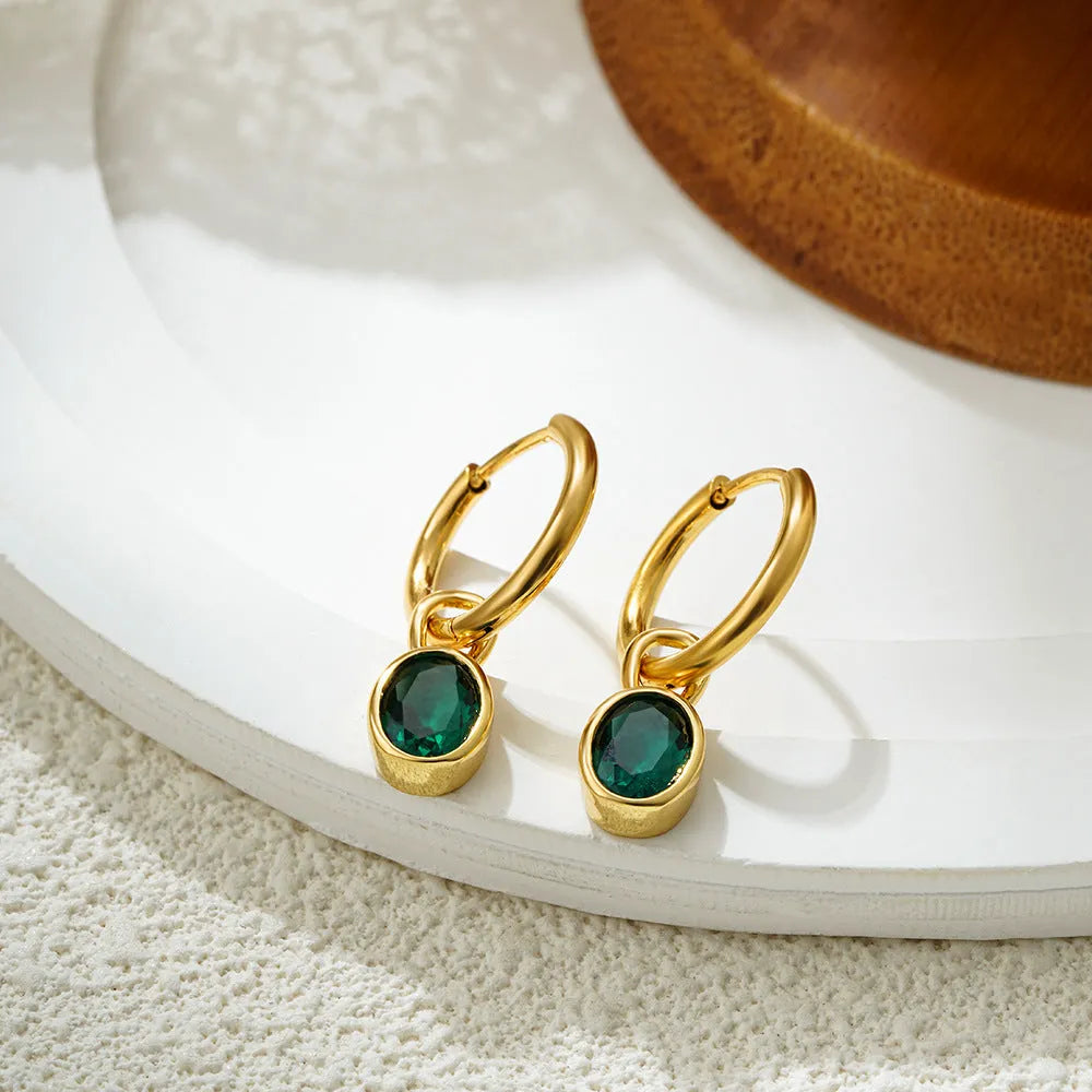 Close-up of a women's retro-style oval zircon earring in copper, showing elliptical stone setting and textured metal finish.