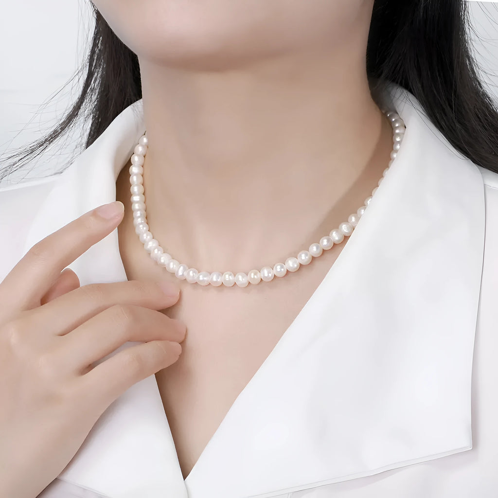 Close-up of a women's adjustable sterling silver necklace with a 6-7mm natural freshwater pearl pendant.