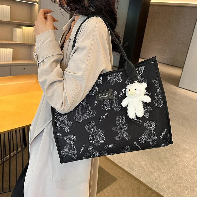Women's black canvas tote bag with rhombus pattern and horizontal square design
