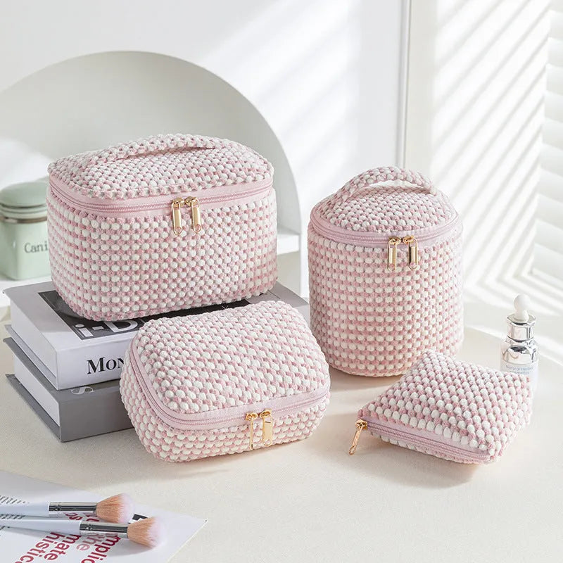 Four cube-shaped flannelette makeup bags in a set, showing pink dots and solid colour options.