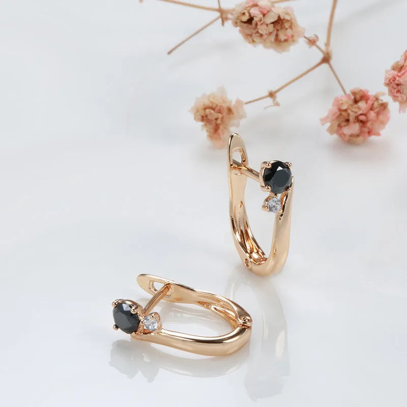 Gold geometric drop earrings with black agate stone accents on copper base