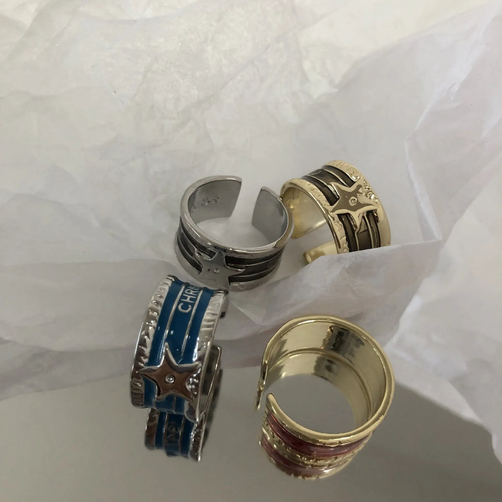 Geometric adjustable copper ring with a distressed XINGX drop oil pattern in multiple colour options.